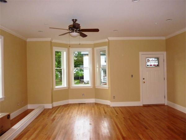 81 Ash Street, Unit 2 Waltham, MA 02453 - Photo 4 of 5 a view of an empty room with wooden floor and a window