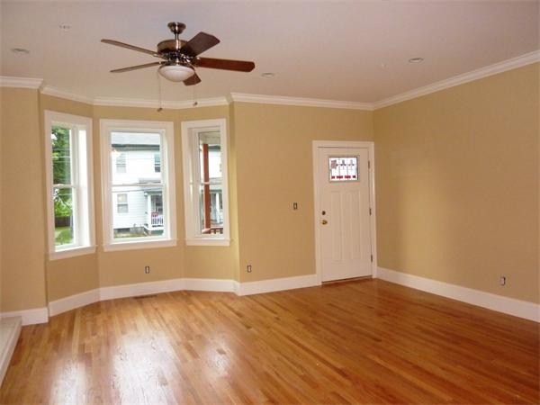 81 Ash Street, Unit 2 Waltham, MA 02453 - Photo 5 of 5 a view of an empty room with a window and wooden floor