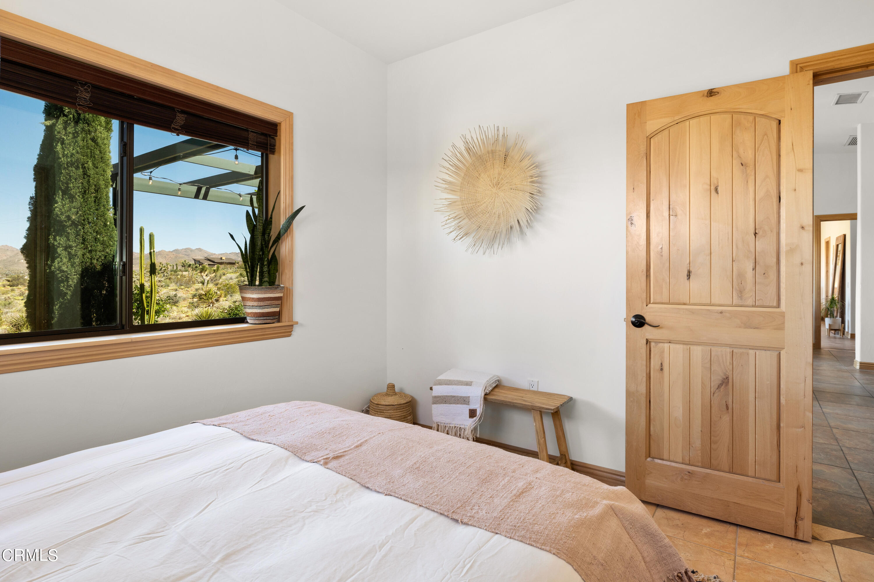 8331 Sunset Road Joshua Tree, CA 92252 - Photo 21 of 58 a bedroom with a bed and a painting on the wall