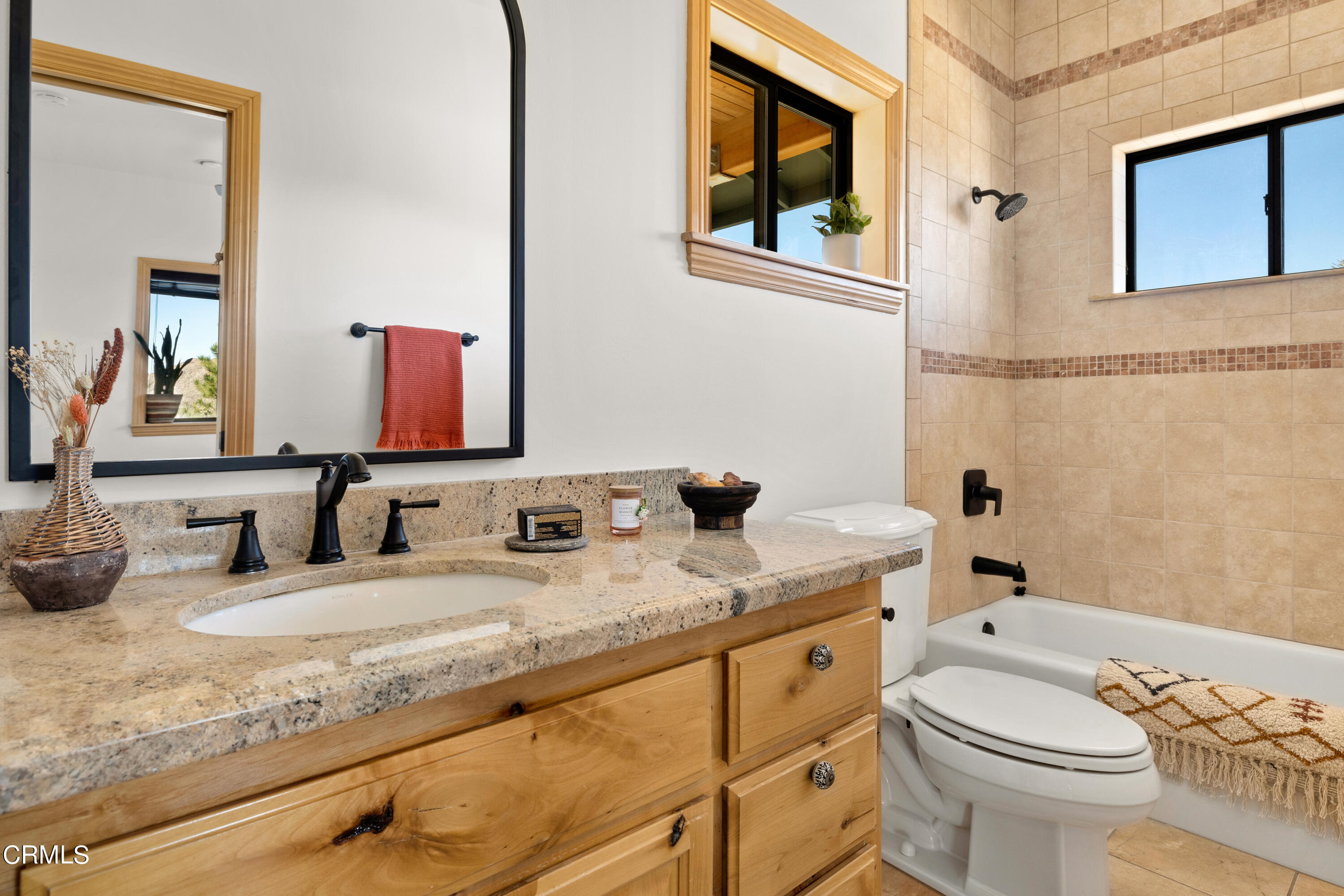 8331 Sunset Road Joshua Tree, CA 92252 - Photo 23 of 58 a bathroom with a granite countertop toilet sink and mirror