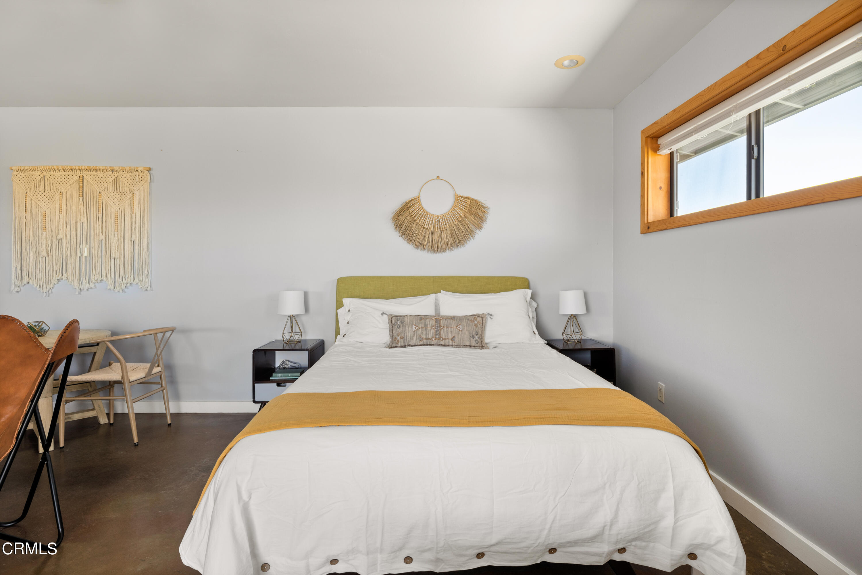 8331 Sunset Road Joshua Tree, CA 92252 - Photo 35 of 58 a bedroom with a bed and chair