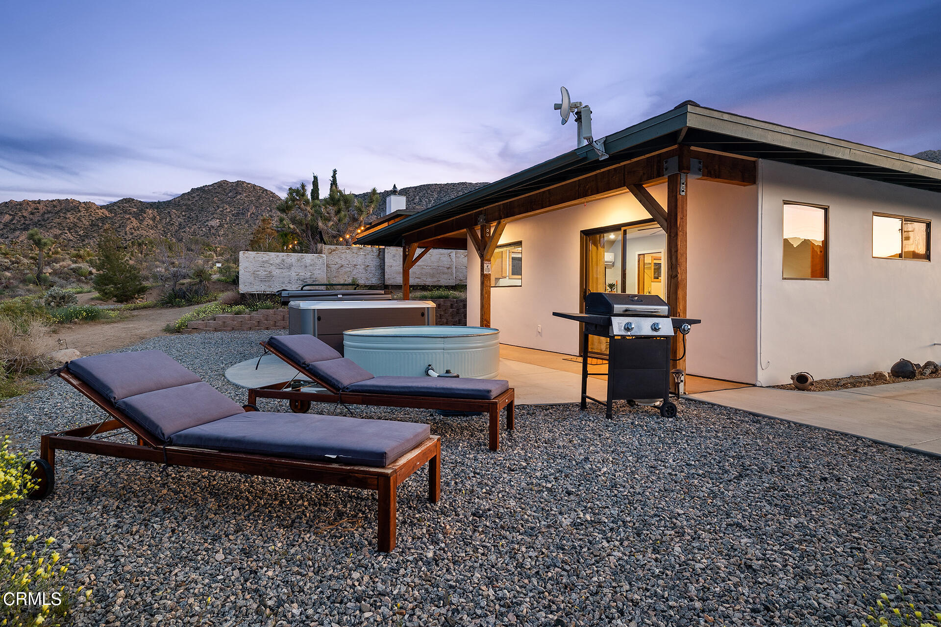 8331 Sunset Road Joshua Tree, CA 92252 - Photo 42 of 58 a backyard of a house with table and chairs