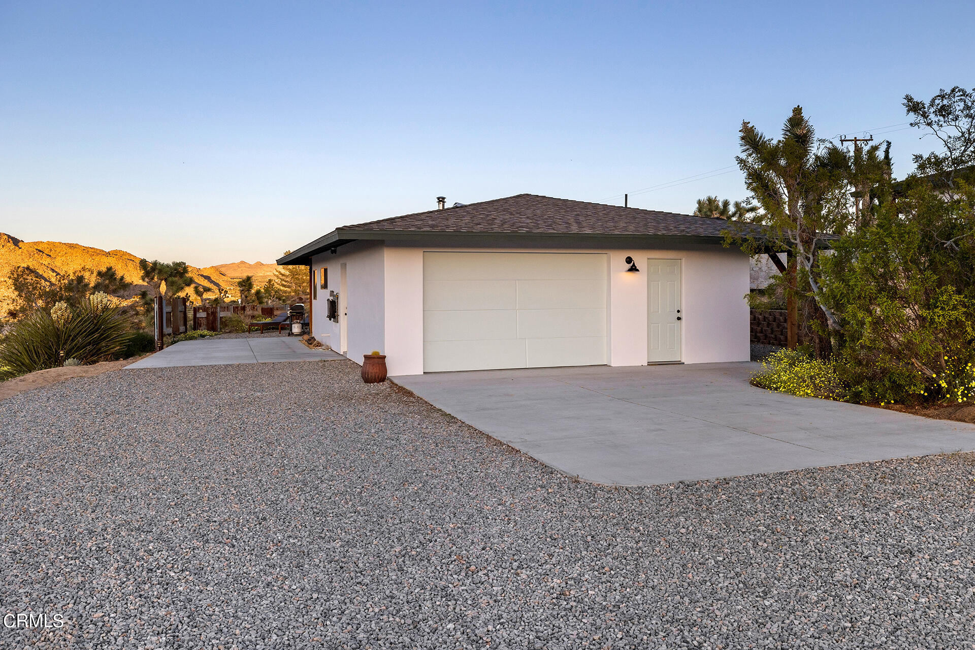 8331 Sunset Road Joshua Tree, CA 92252 - Photo 44 of 58 a view of a house with a yard and garage
