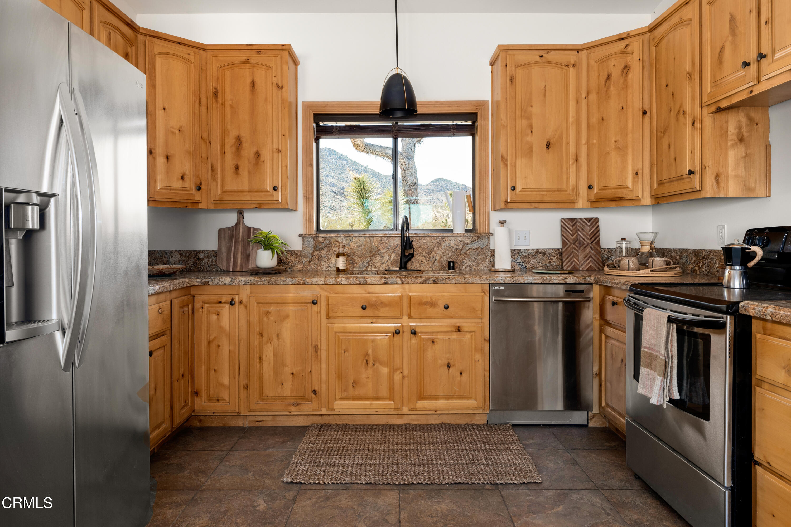 8331 Sunset Road Joshua Tree, CA 92252 - Photo 8 of 58 a kitchen with stainless steel appliances a stove a sink and a refrigerator with wooden floor