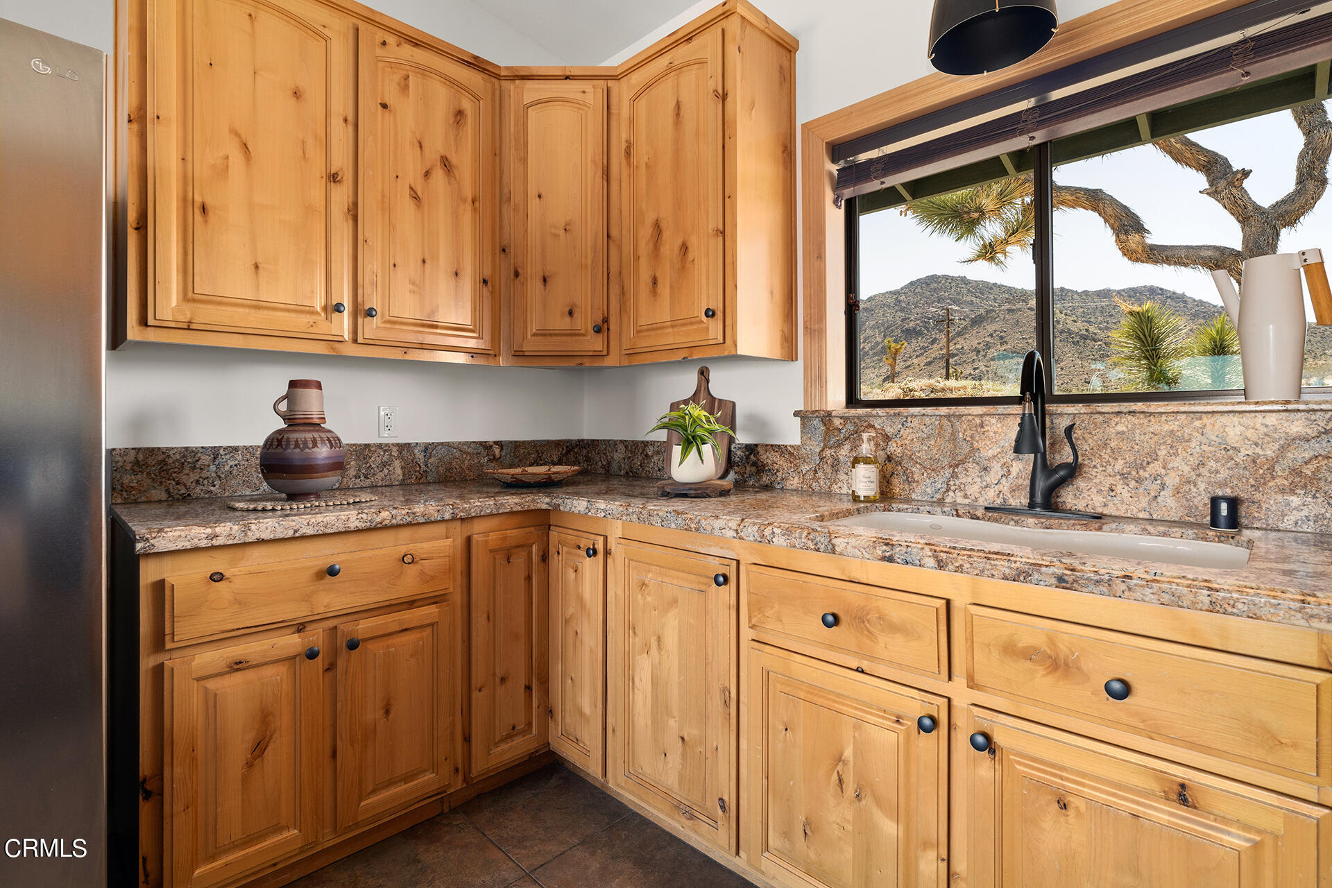 8331 Sunset Road Joshua Tree, CA 92252 - Photo 10 of 58 a kitchen with granite countertop white cabinets and white appliances