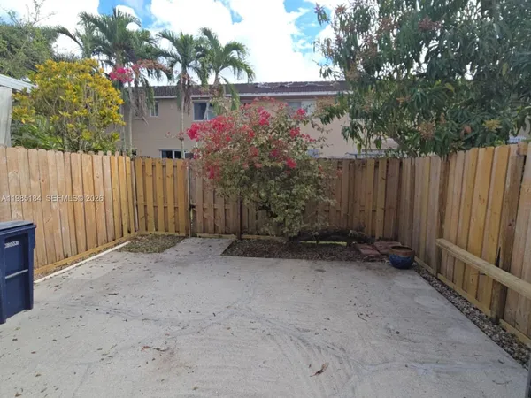 a front view of a house with a tree