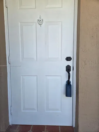 a view of a hallway to rooms