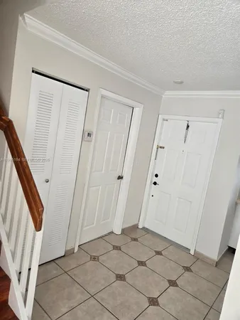 a kitchen with cabinets and stainless steel appliances