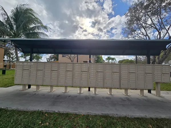 a view of a patio with table and chairs potted plants