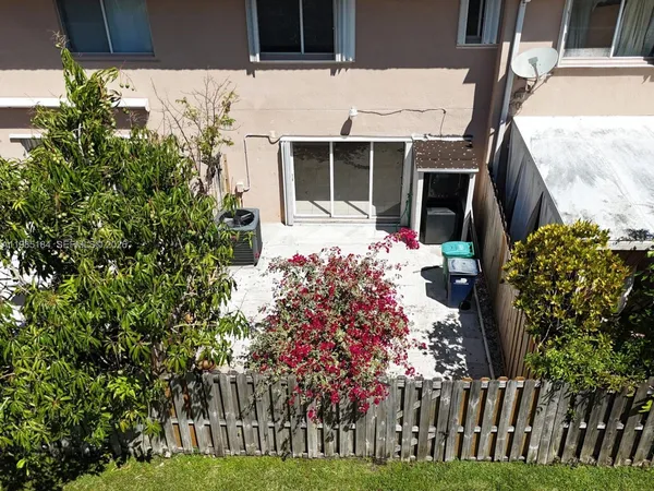 a view of a house with a yard and pathway