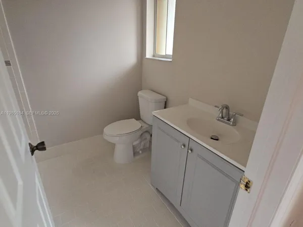 a kitchen with a sink a refrigerator and cabinets