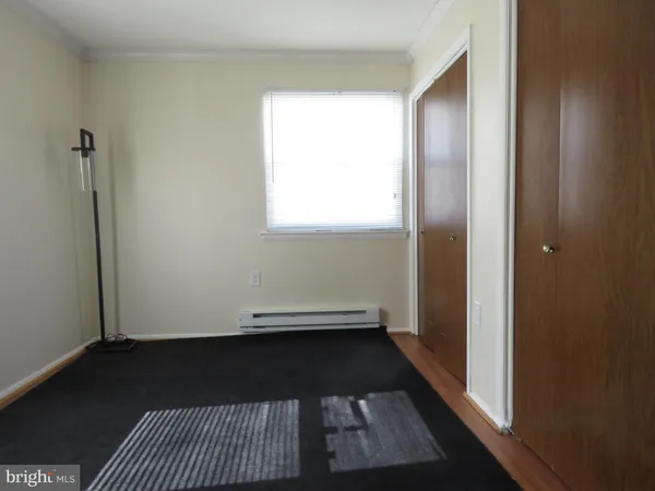 a view of a room with wooden floor and a window