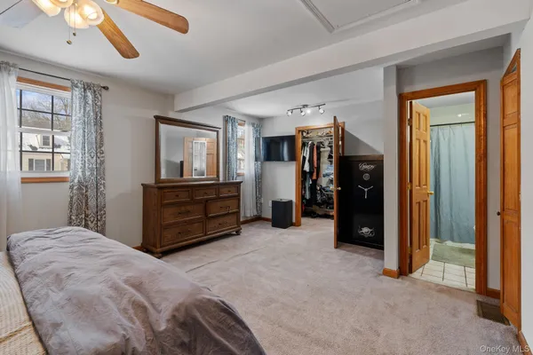 a spacious bedroom with a bed and a chandelier