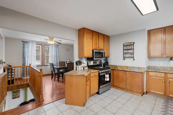 a kitchen with stainless steel appliances a stove a microwave a sink and cabinets