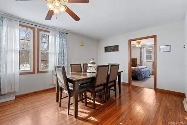 a kitchen with stainless steel appliances granite countertop a stove top oven a sink a dining table and chairs