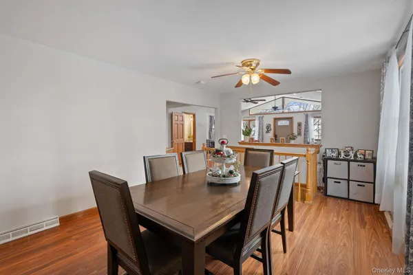 a view of a dining room with furniture wooden floor and chandelier