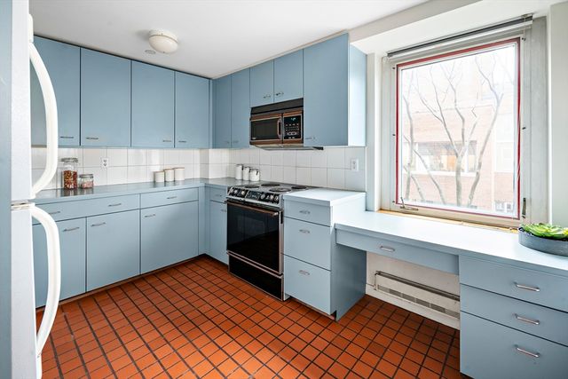 a kitchen with stainless steel appliances a sink stove and cabinets