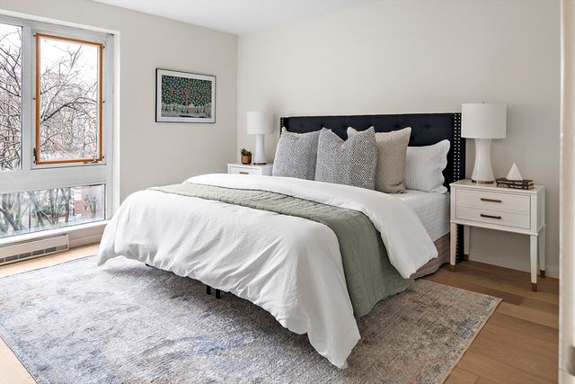 a bed sitting in a bedroom next to a window