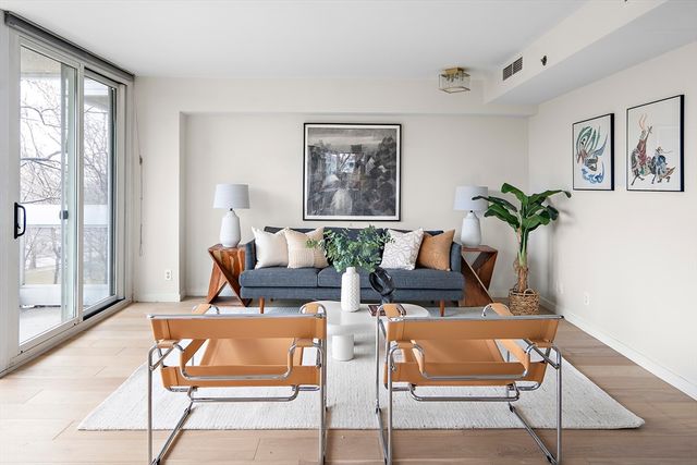 a living room with furniture lamp and window