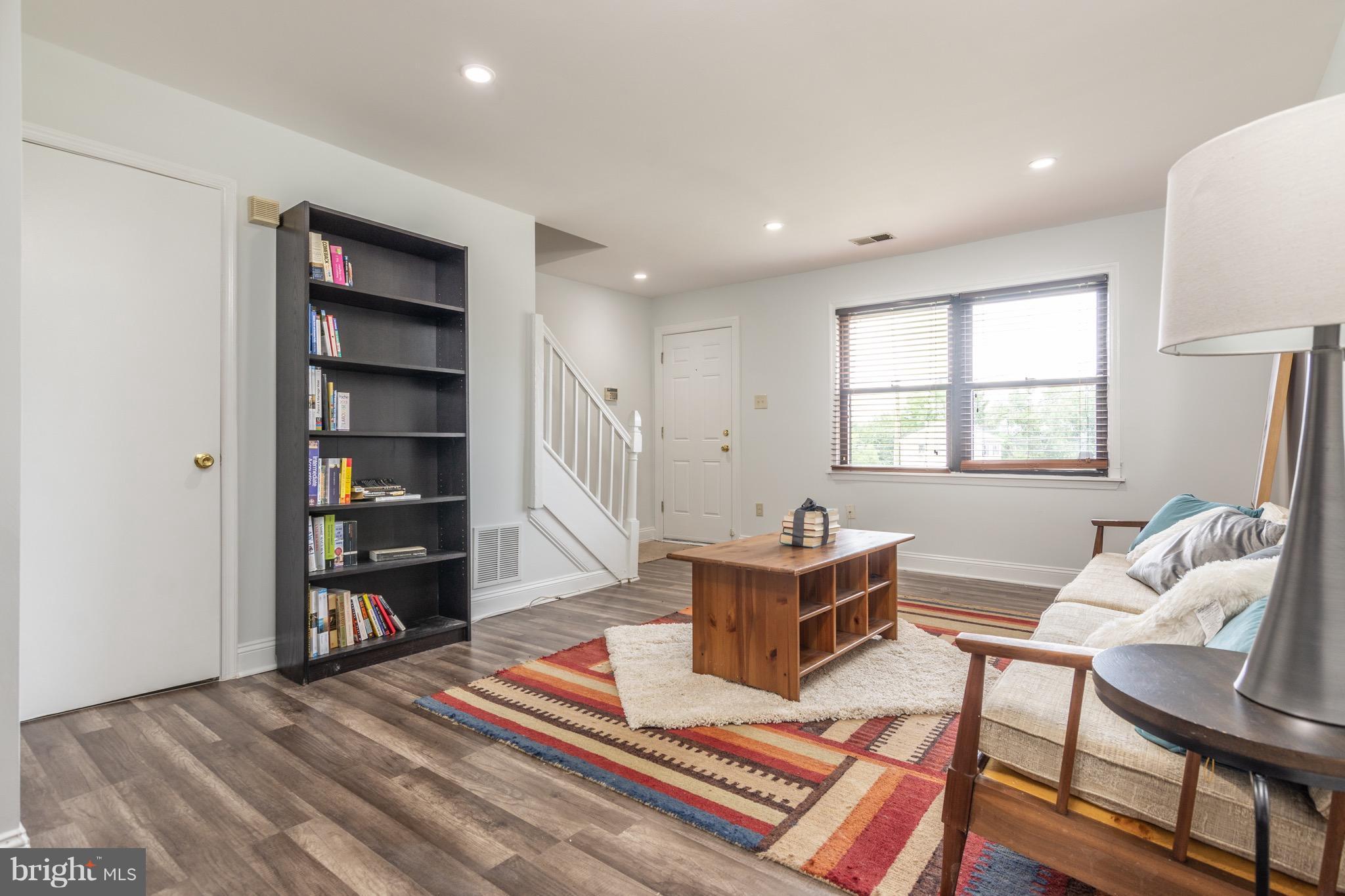 5017 Sheriff Road Northeast Washington, DC 20019 - Photo 5 of 22 a living room with furniture a window and a bookshelf