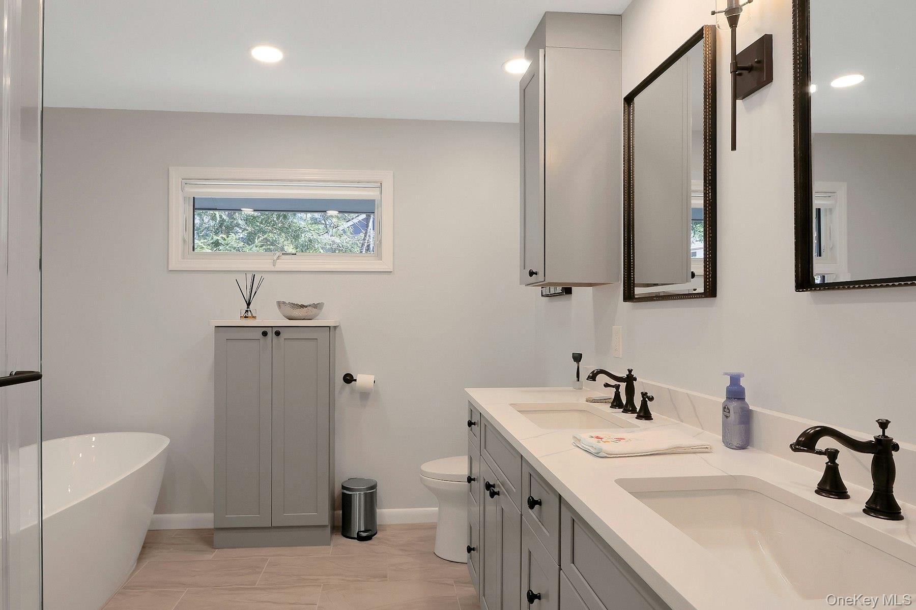 27 Deerpath Road Tuxedo Park, NY 10987 - Photo 15 of 32 a bathroom with a sink a large mirror and a bathtub