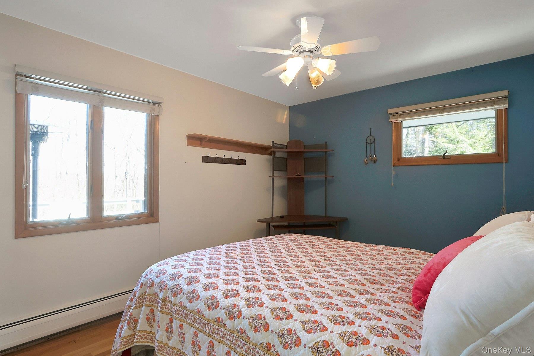 27 Deerpath Road Tuxedo Park, NY 10987 - Photo 19 of 32 a bedroom with a bed and a chandelier