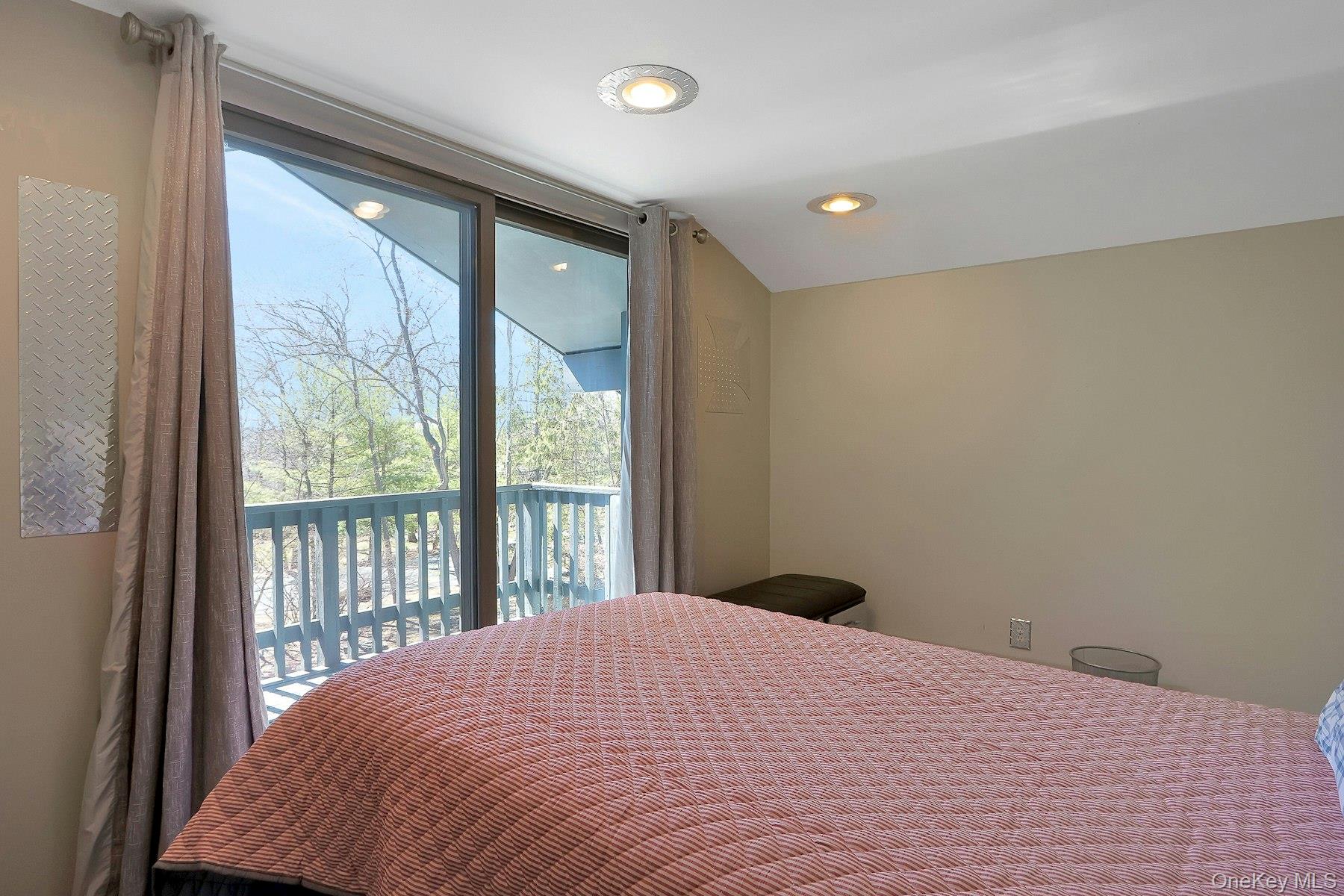 27 Deerpath Road Tuxedo Park, NY 10987 - Photo 21 of 32 a bedroom with a large window and a balcony