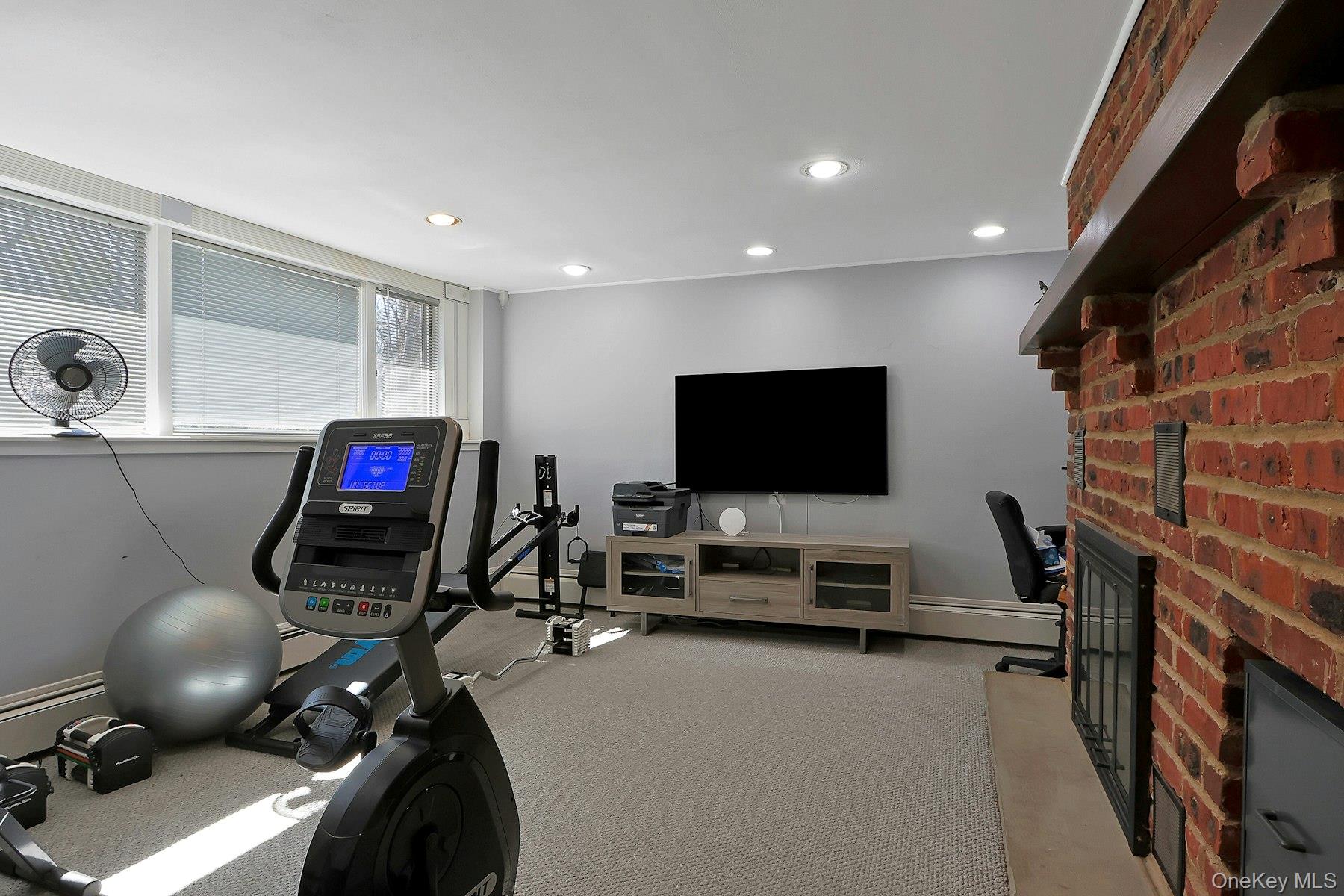 27 Deerpath Road Tuxedo Park, NY 10987 - Photo 23 of 32 a living room with furniture and a flat screen tv