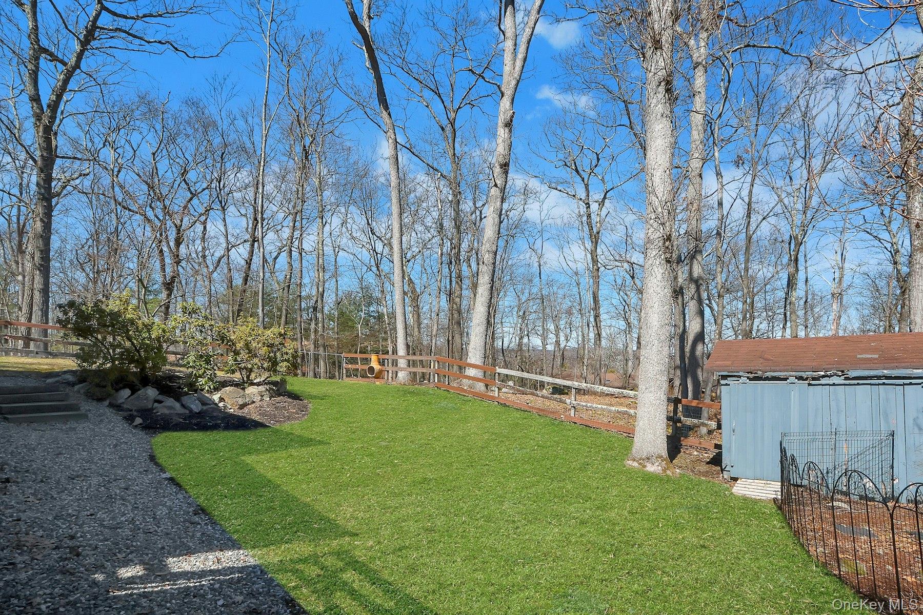 27 Deerpath Road Tuxedo Park, NY 10987 - Photo 27 of 32 a backyard of a house with lots of green space