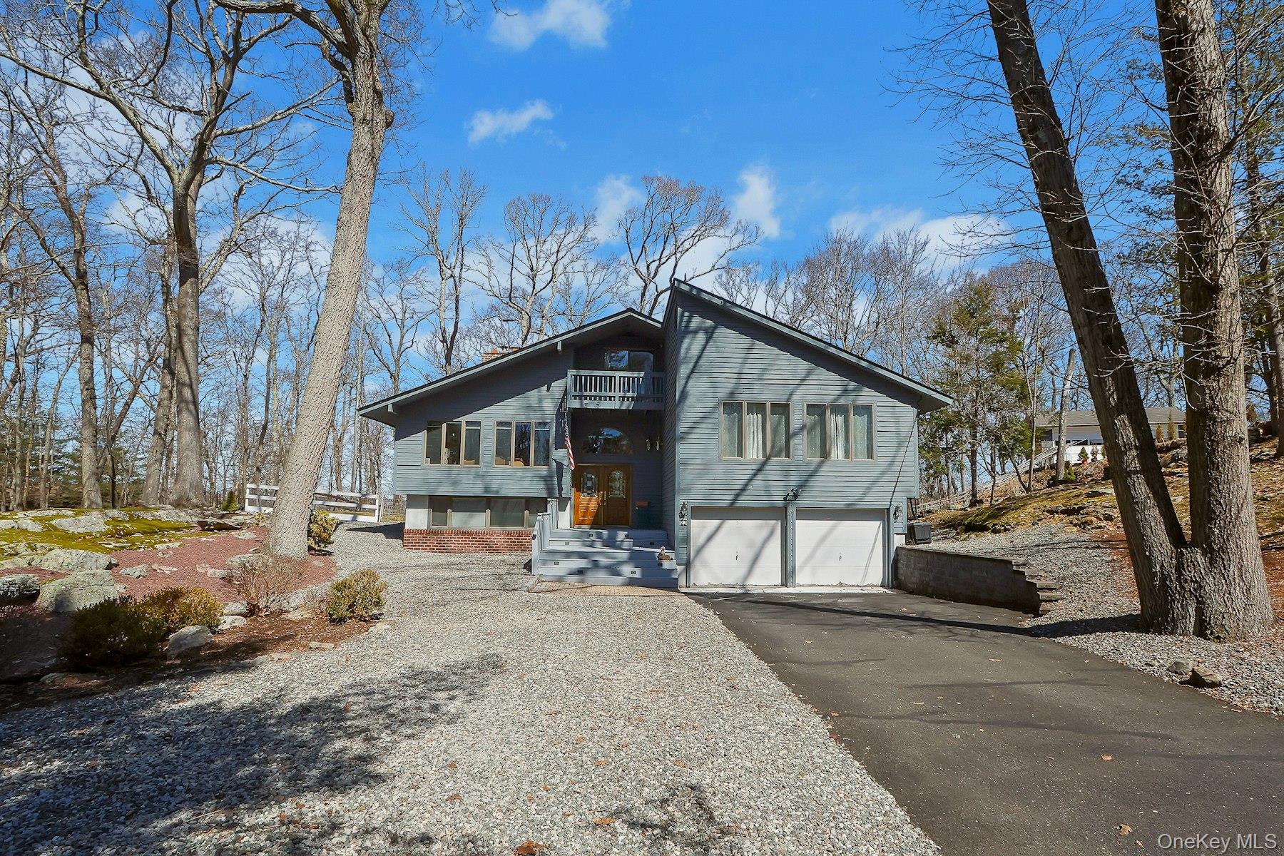 27 Deerpath Road Tuxedo Park, NY 10987 - Photo 29 of 32 a view of a house with a yard covered in snow