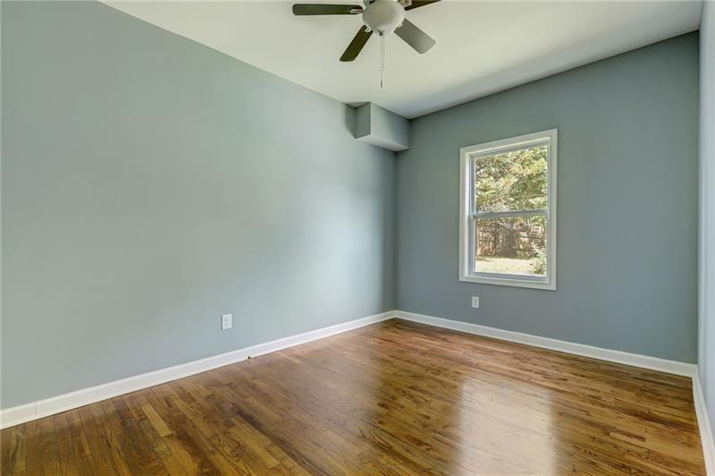 807 A Gilbert Street Southeast, Unit A Atlanta, GA 30316 - Photo 11 of 25 an empty room with a window and ceiling fan