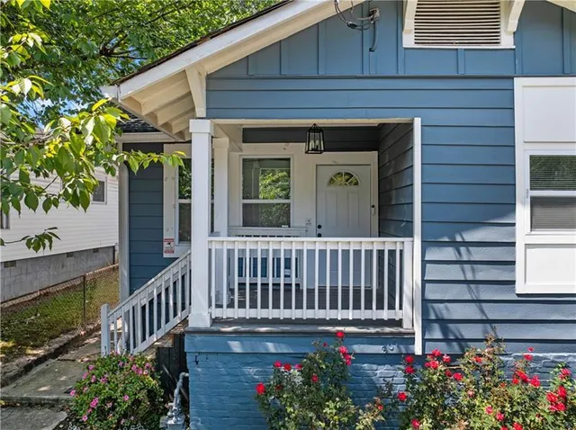 a view of a porch with a flower garden