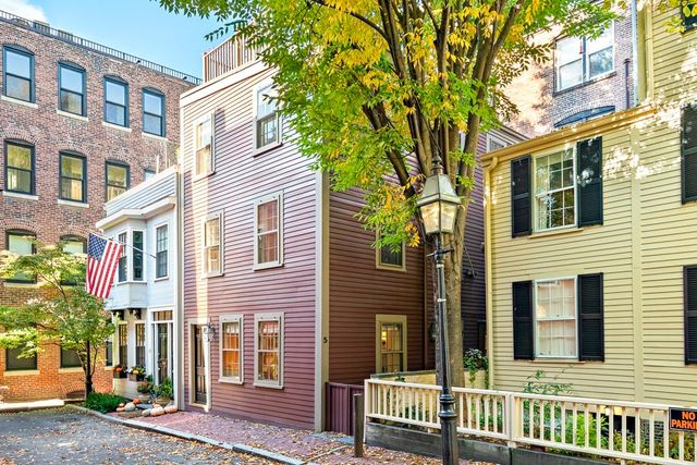 a view of a brick building next to a road
