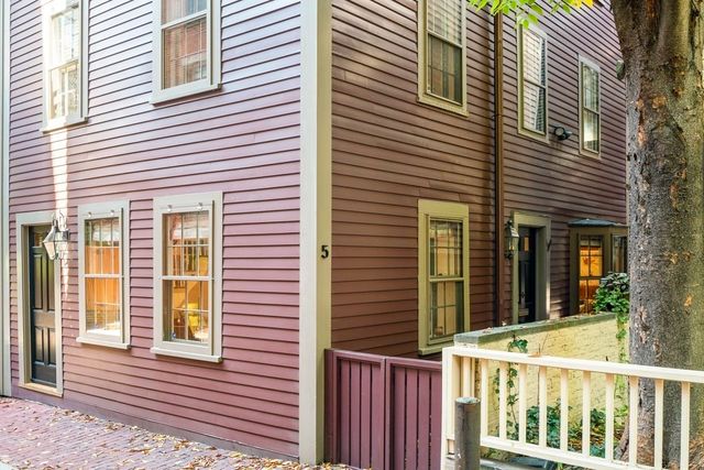 a view of a brick house with a large window