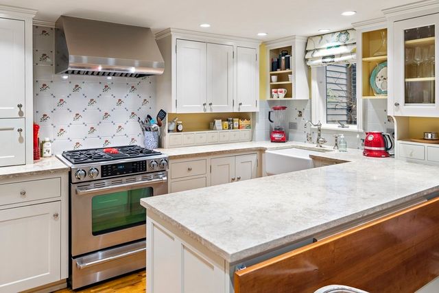 a kitchen with stainless steel appliances granite countertop a stove and a sink