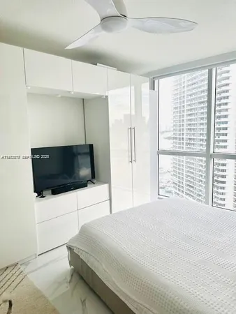 a bedroom with a bed and a flat screen tv