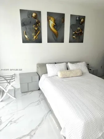 a bedroom with a bed and wall painting