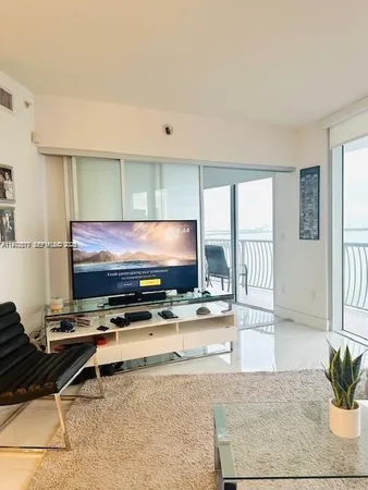 a room with furniture flat screen tv and outdoor view