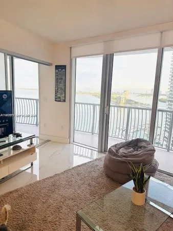 a living room with furniture stove and a window
