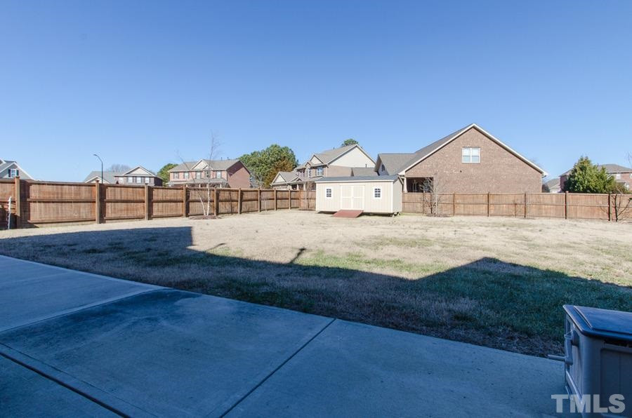 305 Woodlief Farm Road Rolesville, NC 27571 - Photo 24 of 25 Fenced back yard and a very nice storage shed Back Yard