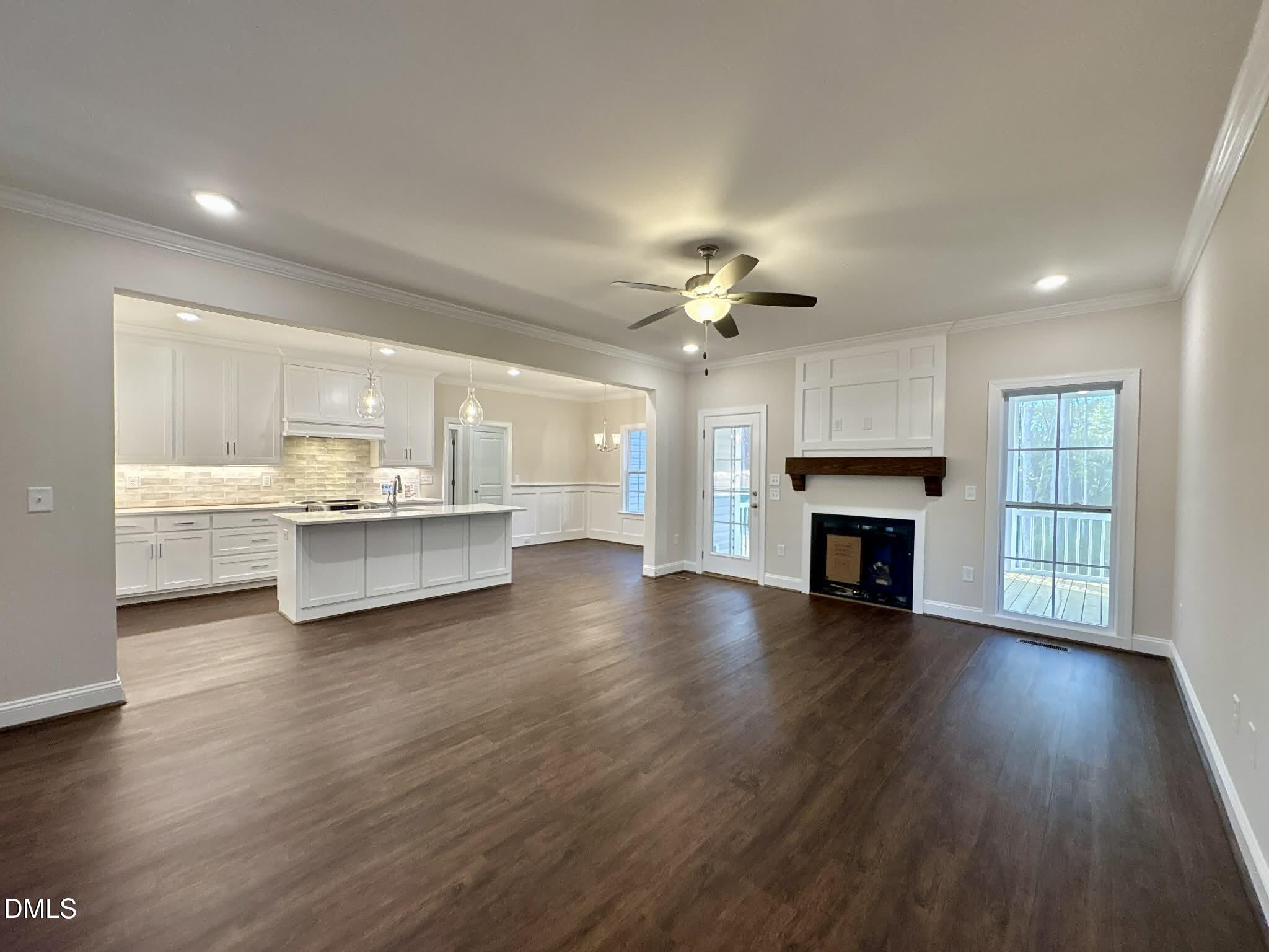 800 Emmett Ct Spring Spring Hope, NC 27882 - Photo 9 of 62 a view of an empty room with wooden floor and kitchen