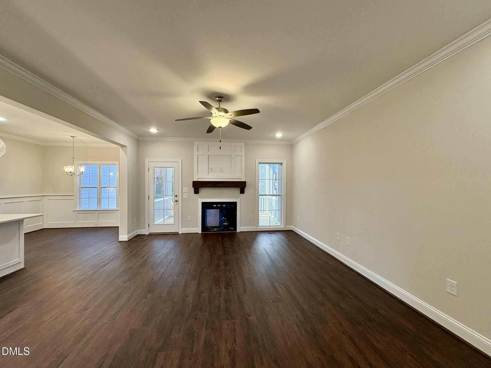 800 Emmett Ct Spring Spring Hope, NC 27882 - Photo 10 of 62 an empty room with wooden floor fireplace and staircase