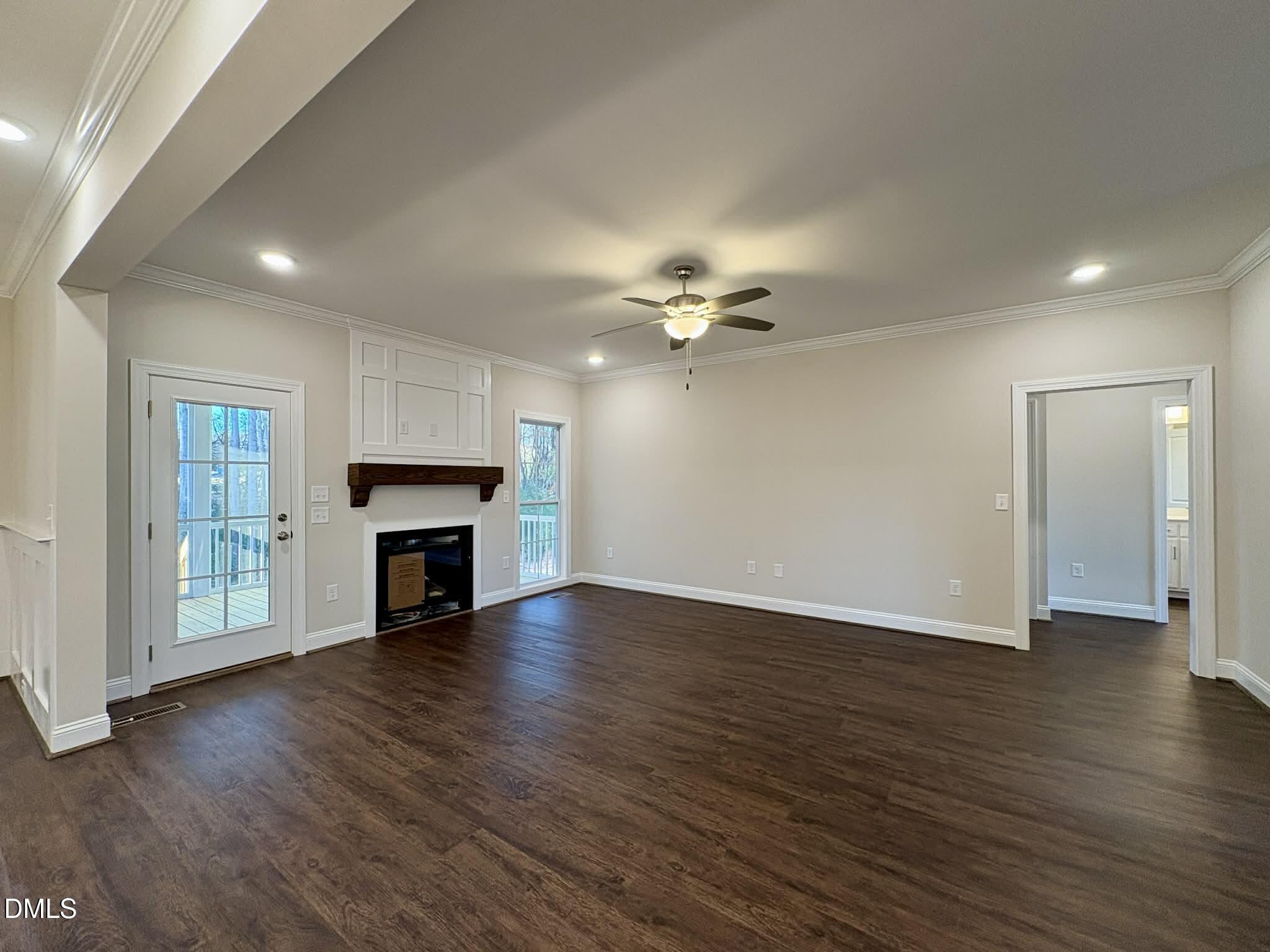 800 Emmett Ct Spring Spring Hope, NC 27882 - Photo 12 of 62 a view of an empty room with wooden floor and a fireplace