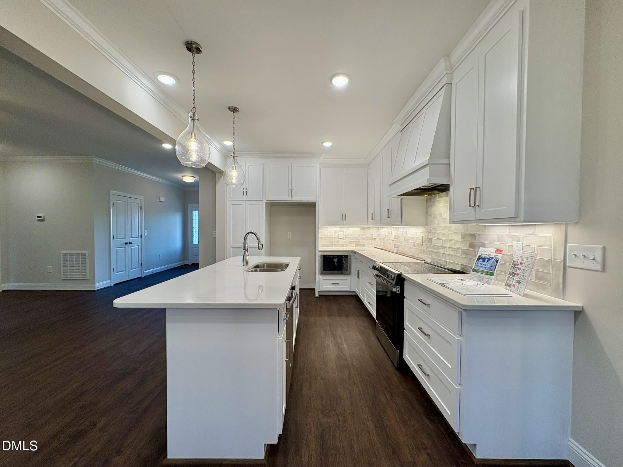 800 Emmett Ct Spring Spring Hope, NC 27882 - Photo 18 of 62 a kitchen with stainless steel appliances kitchen island a sink stove and cabinets