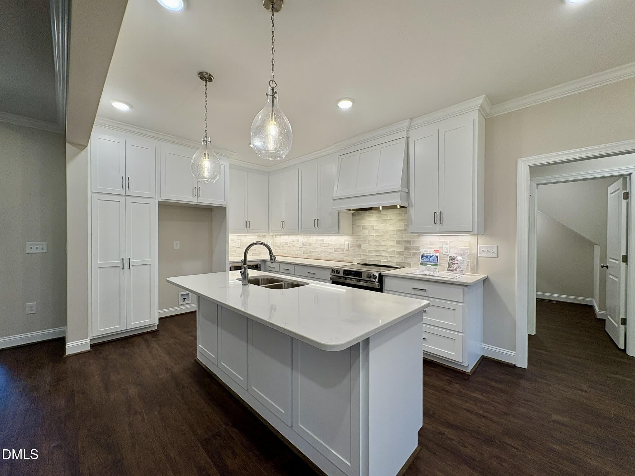 800 Emmett Ct Spring Spring Hope, NC 27882 - Photo 19 of 62 a kitchen with a sink stove and wooden floor
