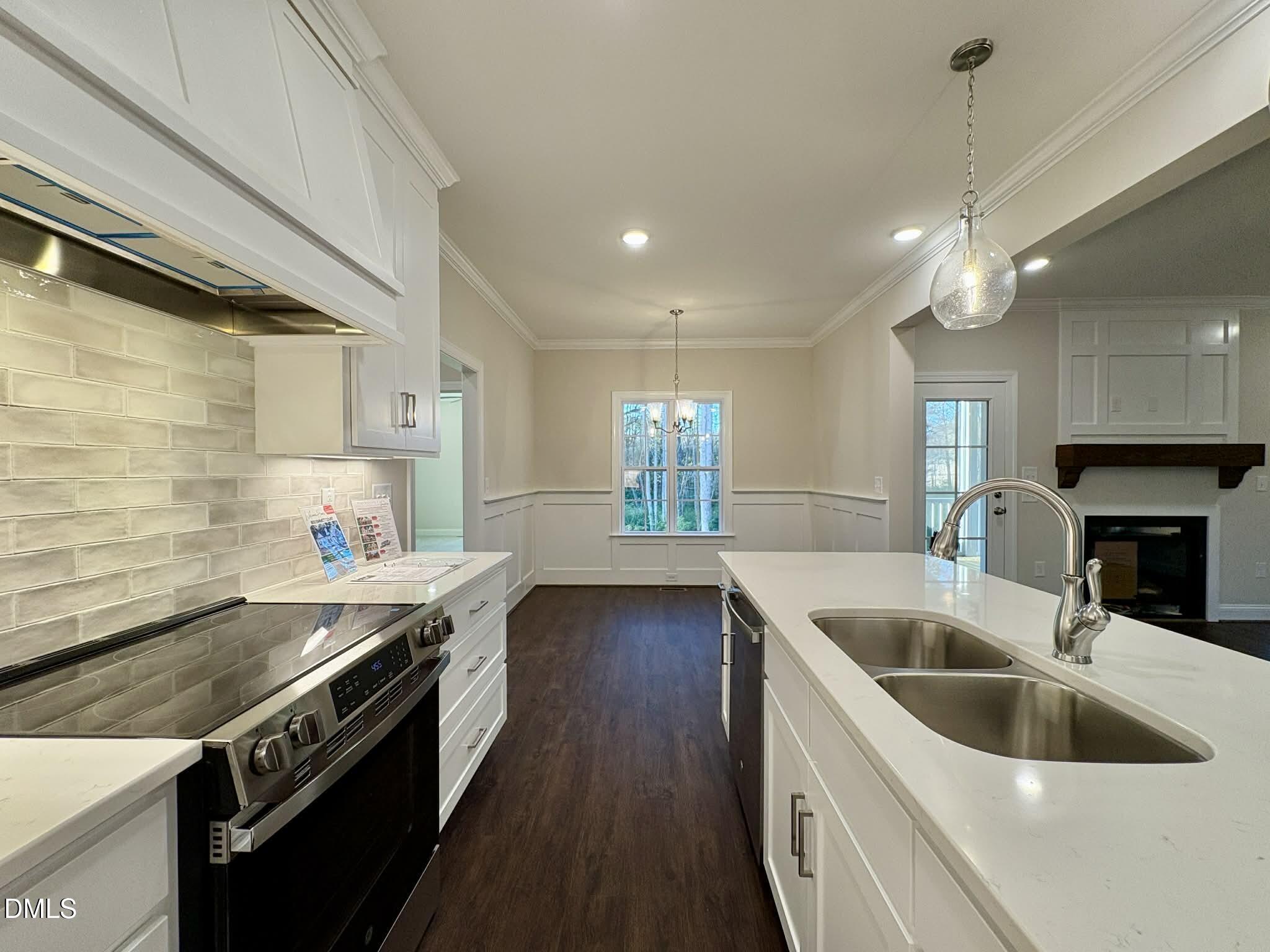 800 Emmett Ct Spring Spring Hope, NC 27882 - Photo 20 of 62 a kitchen with stainless steel appliances granite countertop a sink a stove and a wooden floor
