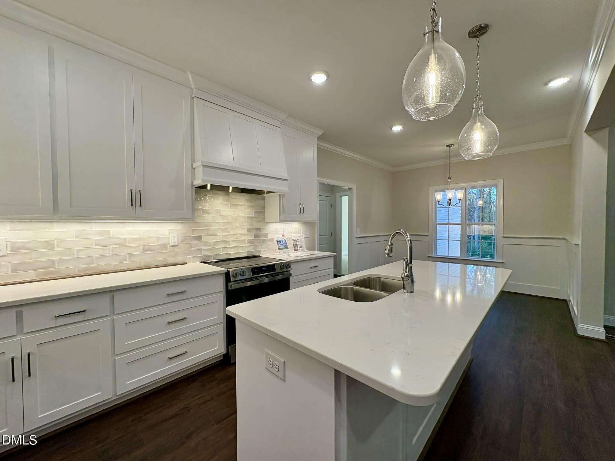 800 Emmett Ct Spring Spring Hope, NC 27882 - Photo 21 of 62 a kitchen with stainless steel appliances granite countertop a sink a stove and a wooden floors
