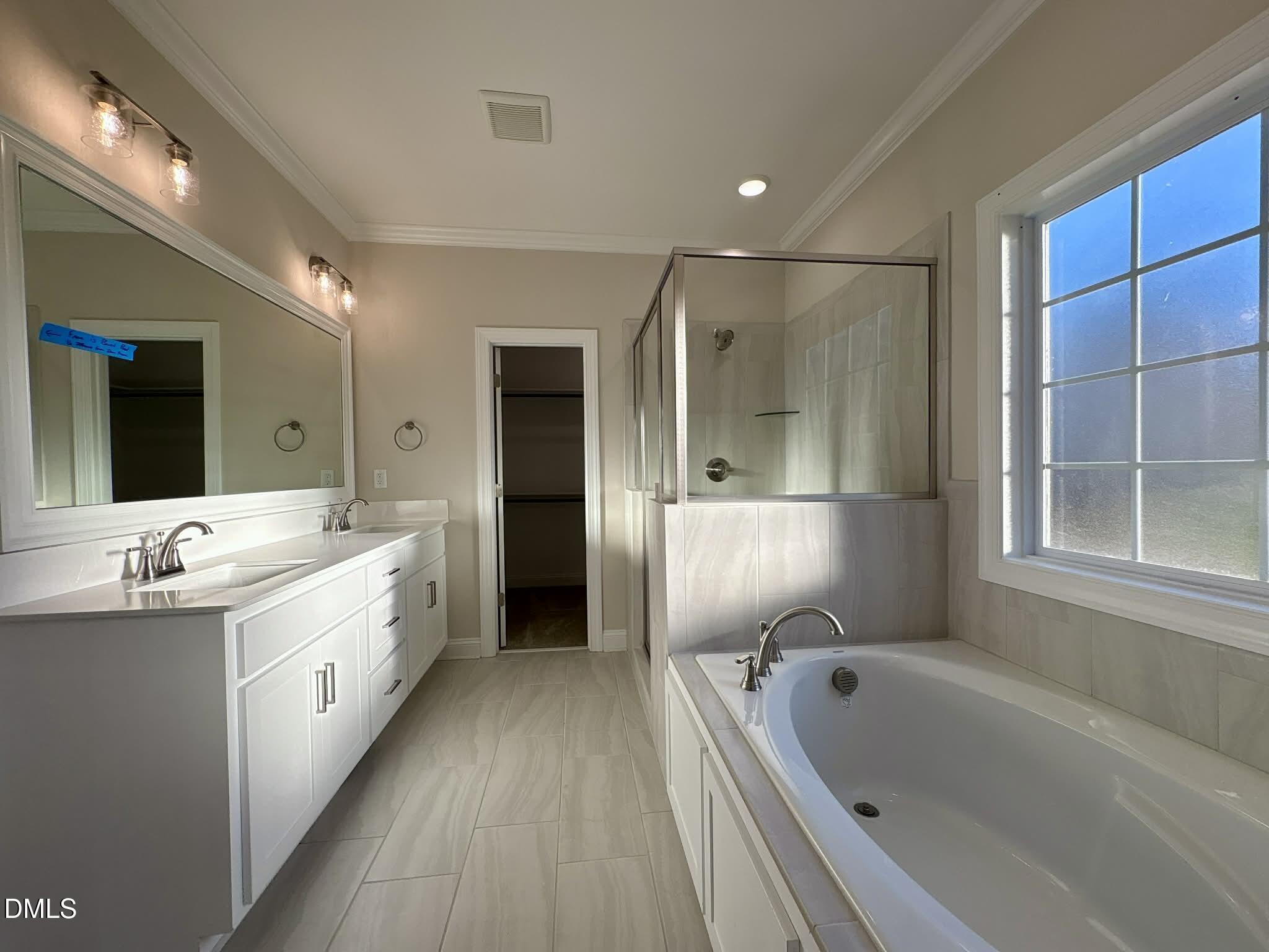 800 Emmett Ct Spring Spring Hope, NC 27882 - Photo 33 of 62 a large bathroom with a tub a double vanity sink and mirror