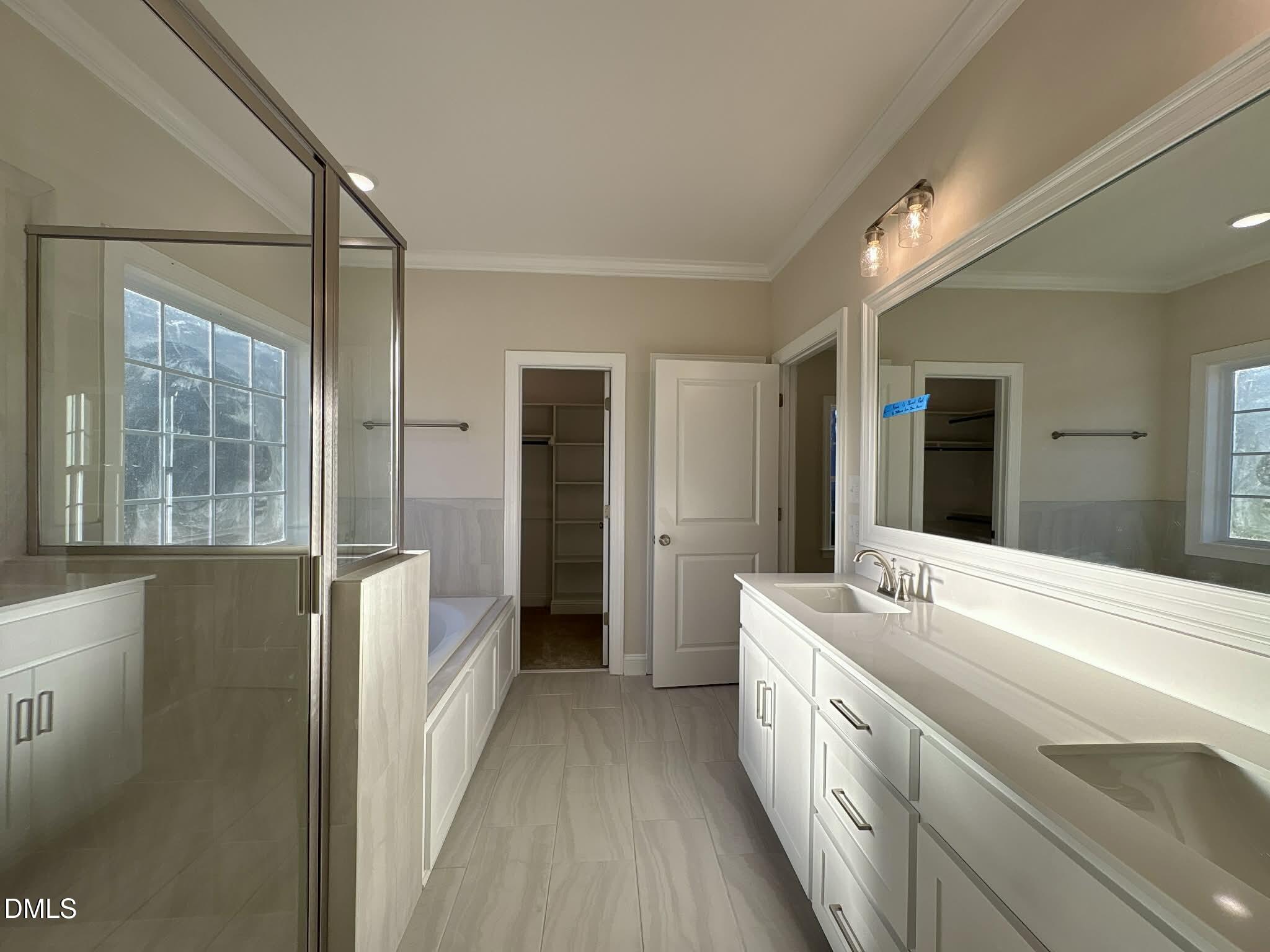 800 Emmett Ct Spring Spring Hope, NC 27882 - Photo 34 of 62 a spacious bathroom with a double vanity sink and a large mirror