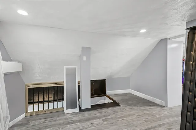 a view of a livingroom with wooden floor and stairs